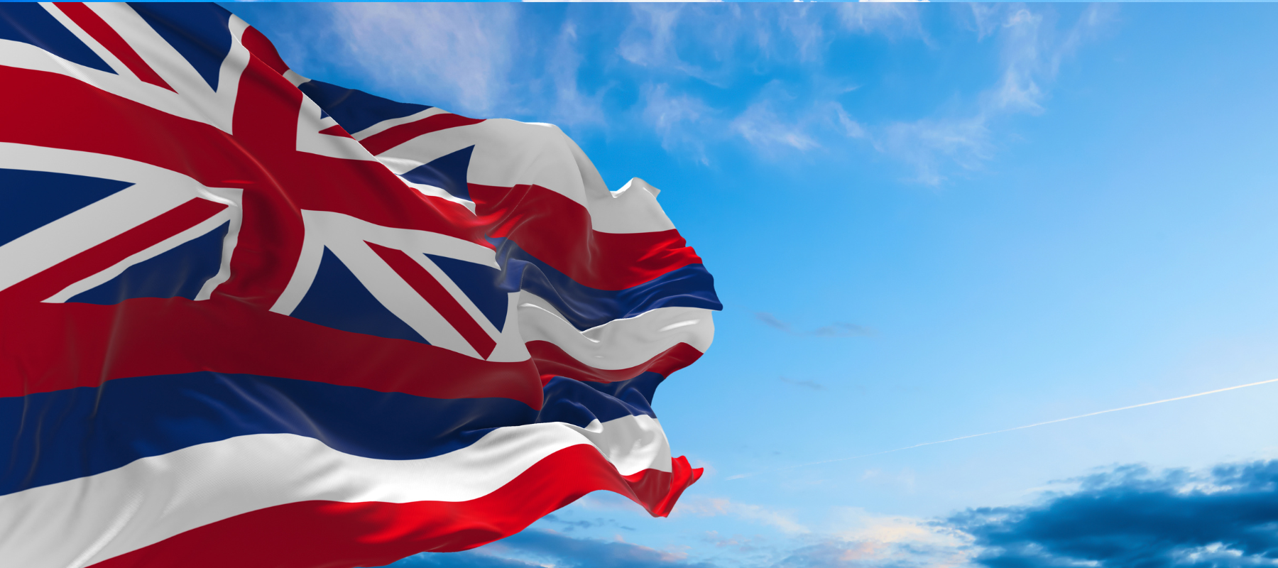 hawaiian flag against a blue sky